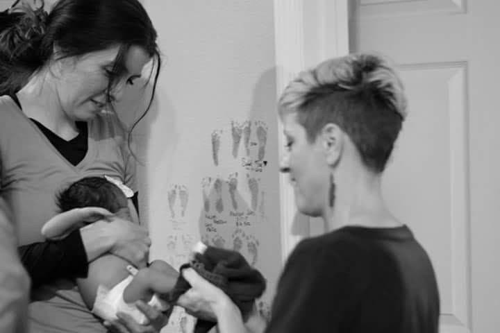 Doula, April Dawn , wiping the feet of a newborn after stamping them at Tree of Life Birth Center in Altamonte Springs.